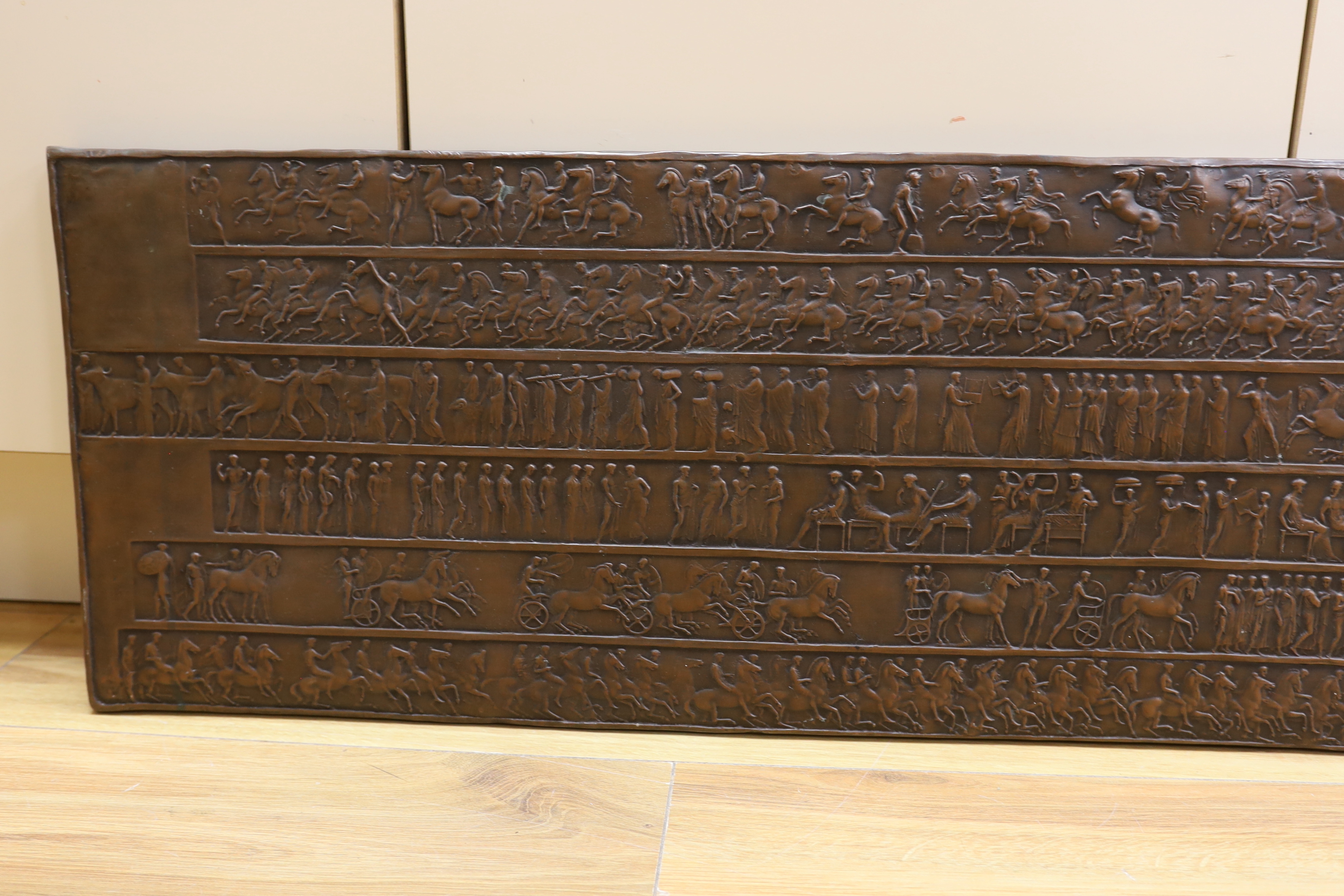 A copper effect resin plaque, 34 x 131cm